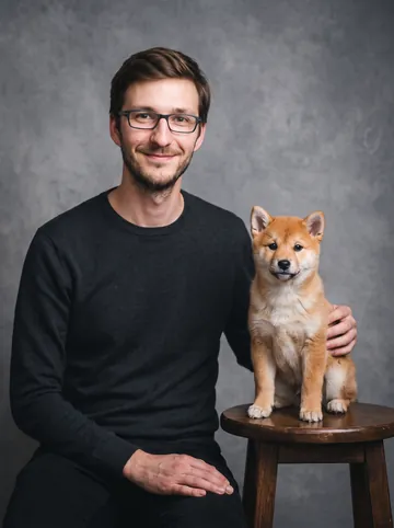 Studio portrait sample: a man with glasses and his shiba inu puppy