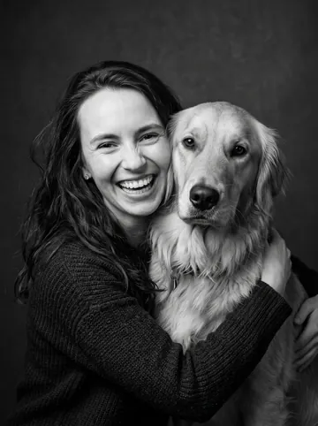 Black and white sample: a woman with long brown hair and her golden retriever