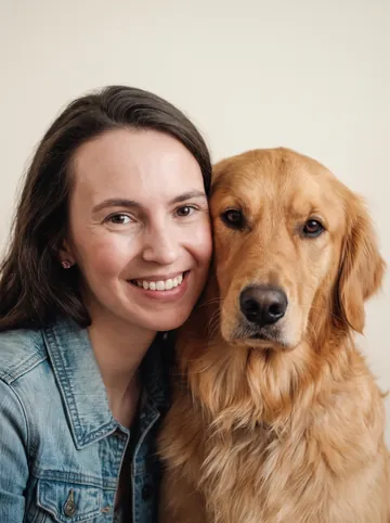 Cheek to cheek sample: a woman with long brown hair and her golden retriever
