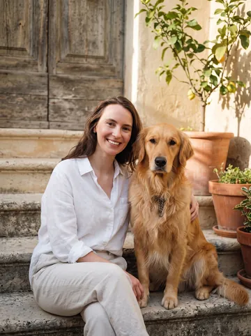 Sunny terrace sample: a woman with long brown hair and her golden retriever